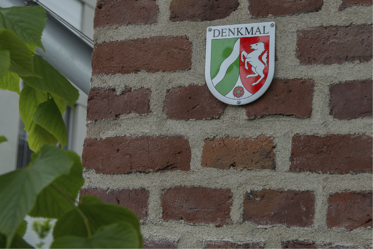 Denkmal-Plakette an der Backsteinfassade